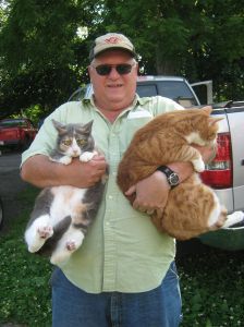 This is us and Grandpaw Jimbo. We love humans. He really loves cats (even though he says he doesn't).